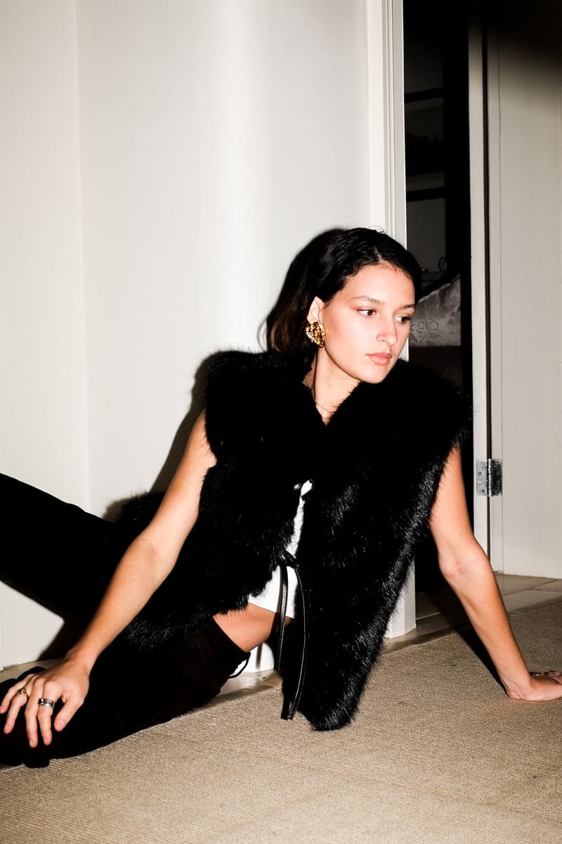 Black Verheyen Serena gilet jacket with a sleek design and zipper closure, displayed on a hanger.