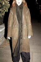 Verheyen ZINA biker green shearling coat on a hanger, showcasing its textured shearling material and stylish design.