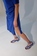 Blue asymmetrical crossover heels by Gvasalia, featuring stylish high heels with unique overlapping straps.