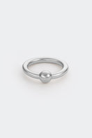 Silver Flow Ring by Poché, a sleek, minimalist silver ring with flowing design, displayed on a plain background.