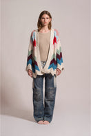 First Born Knits Ziggy knitted cardigan, cozy long-sleeve sweater with textured knit pattern, in a neutral color.