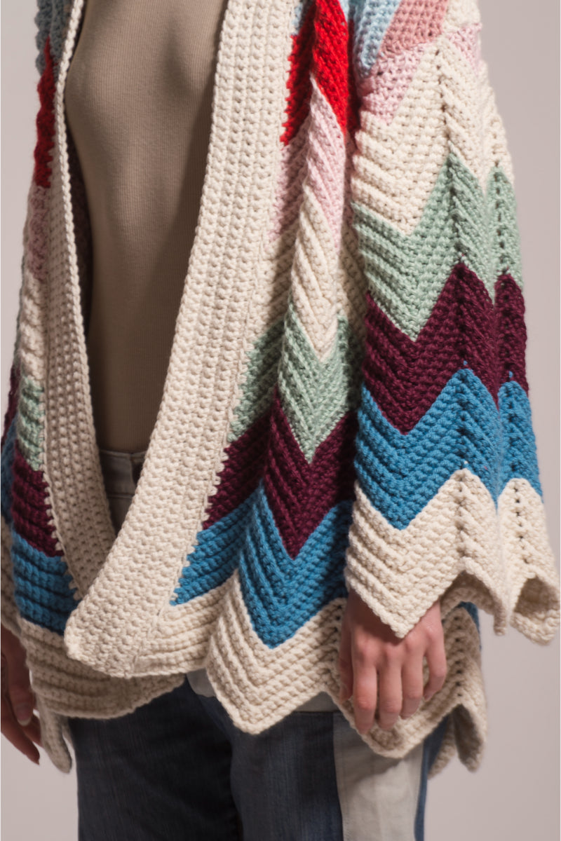 First Born Knits Ziggy knitted cardigan with ribbed cuffs and collar, showcasing soft, cozy fabric in a neutral color.