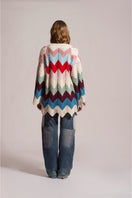 First Born Knits Ziggy knitted cardigan, cozy wool sweater with a textured pattern, displayed on a hanger.