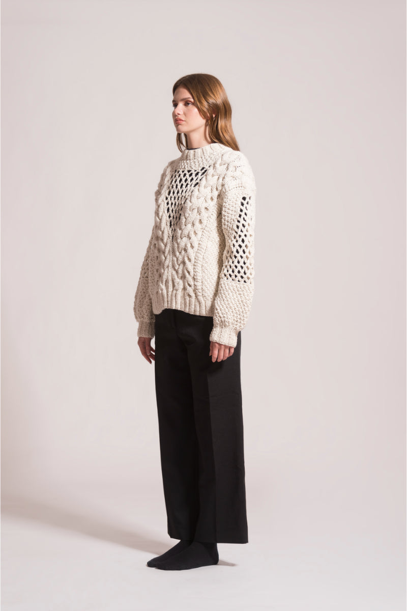 First Born Knits DAFNE knitted sweater featuring a cozy, textured design in neutral tones, perfect for casual wear.