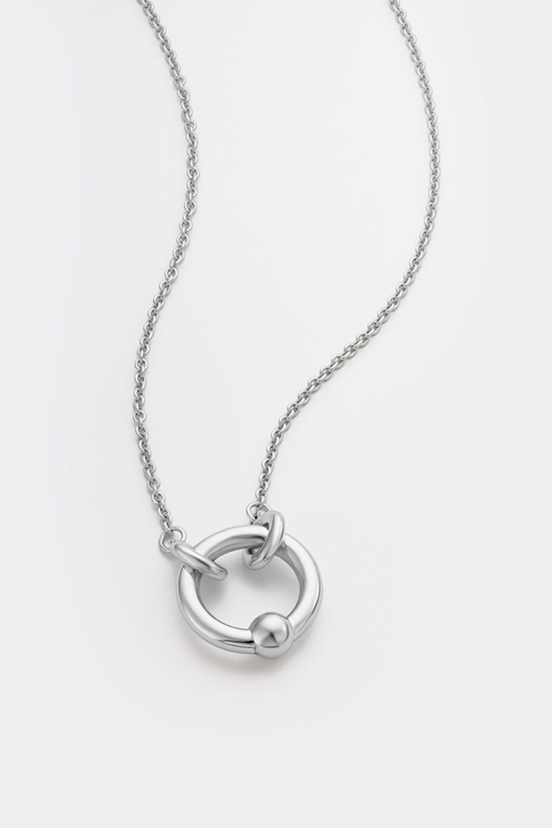 Silver Flow Necklace by Poché, featuring a sleek, modern design with smooth curves, displayed on a neutral background.