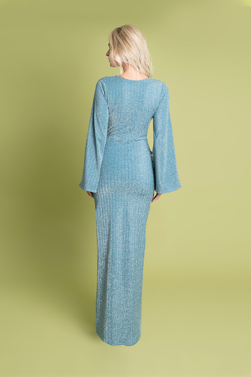 Blue Laura Escobar Centella maxi dress displayed on a hanger with flowing fabric and elegant design.
