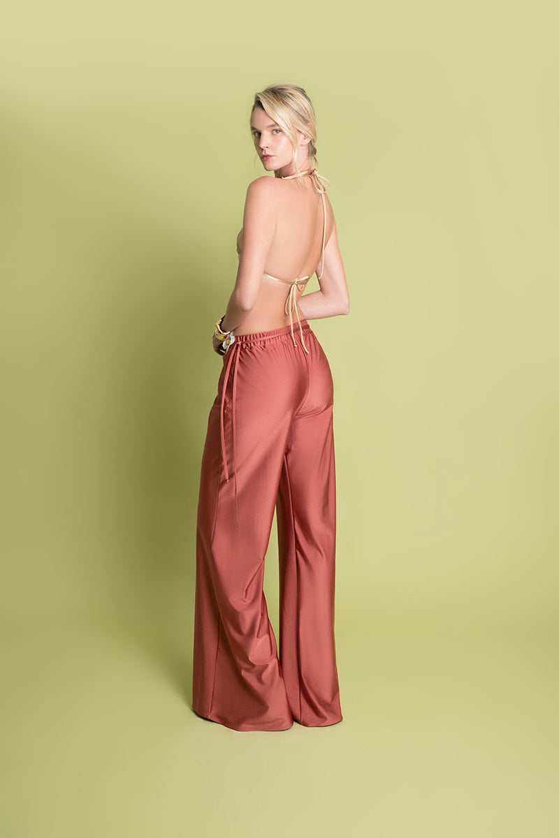 LAURA ESCOBAR Flora Pants in Coral, stylish women’s pants with a vibrant coral color, shown on a model.