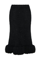Black Lalo midi skirt with high-waisted, knitted textured design, showcasing its elegant flow and detailed fabric.