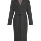 Gvasalia double-breasted coat with back detailing, tailored fit, and classic lapel design, displayed on a hanger.