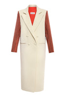 Gvasalia double breasted coat with striped sleeves, tailored fit, and classic design, displayed on a hanger.