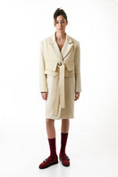 Gvasalia double-breasted coat with matching vest, stylish outerwear featuring classic tailoring and button details.