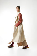 Gvasalia double-breasted coat with striped sleeves, stylish outerwear featuring classic design and contrasting striped accents.