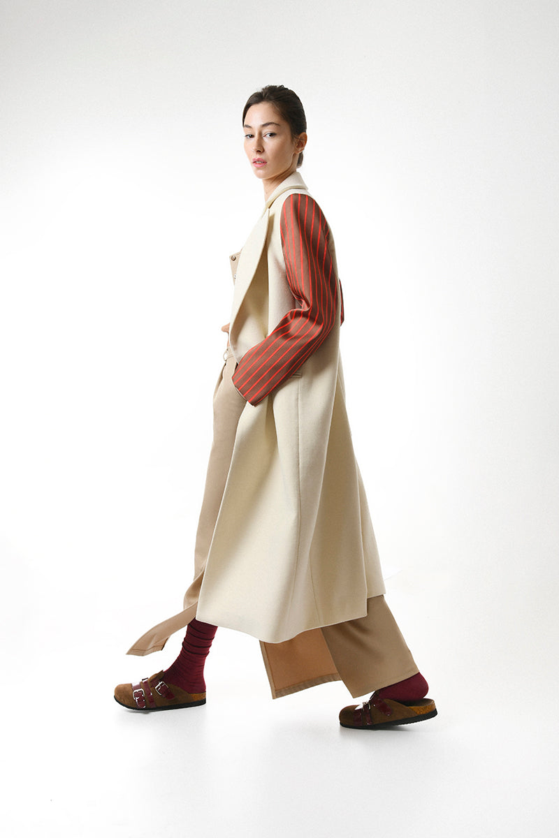 Gvasalia double-breasted coat with striped sleeves, stylish outerwear featuring classic design and contrasting striped accents.