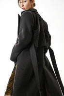 Gvasalia double-breasted coat with back detailing, showcasing tailored design and textured fabric for a stylish outerwear look.