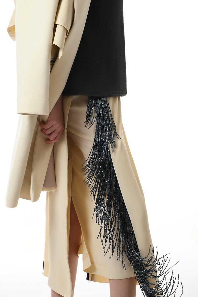 Gvasalia double-breasted midi skirt with beaded fringe, featuring tailored design and intricate beadwork along the hem.