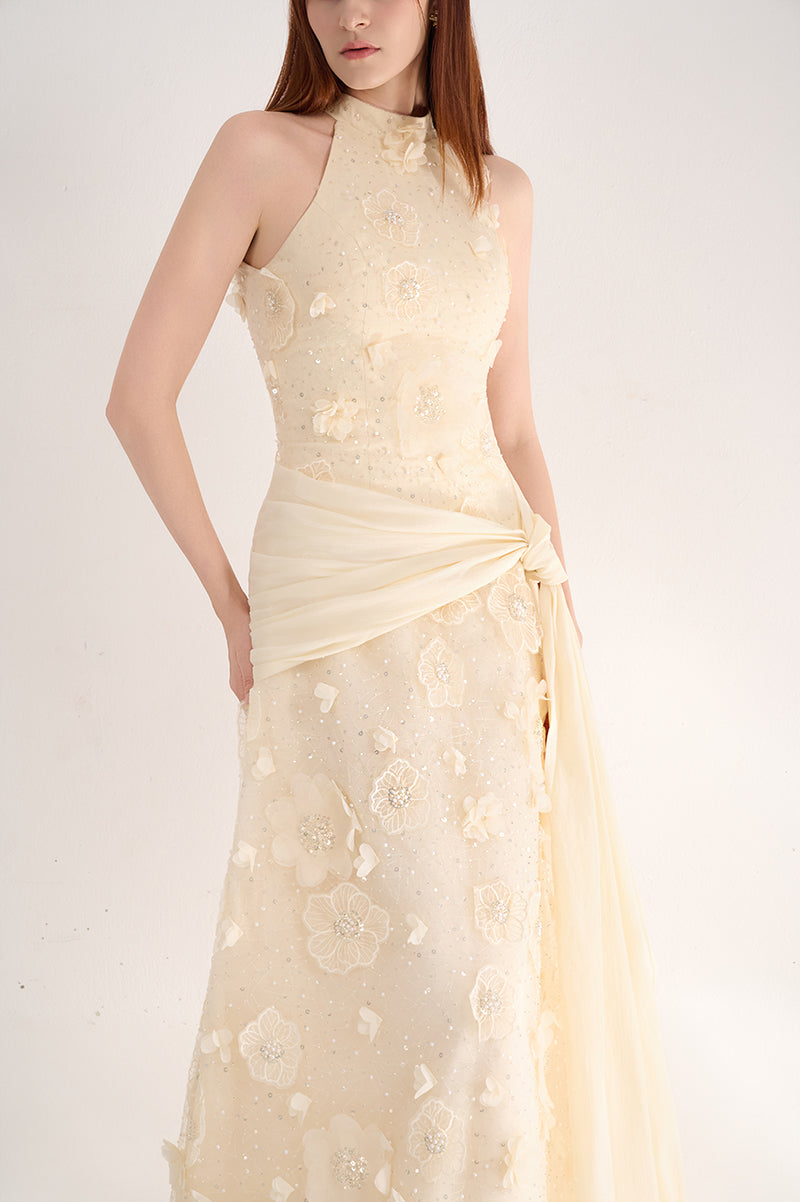 Elegant halter neck gown with floral details by Happy Clothing, featuring a flowing design and intricate floral embellishments.