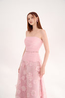 Pink strapless gown with floral details by Happy Clothing, featuring elegant fabric and a flowing silhouette.