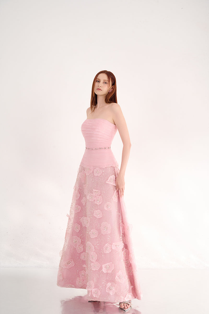 Pink strapless gown with floral details by Happy Clothing, featuring a flowing design and elegant fabric.