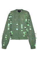 Green hand-knit Lalo cardigan with embellishments, showcasing intricate knit details and decorative accents.