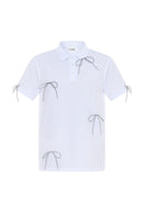 Gvasalia white polo shirt with crystal bow ties, stylish tops featuring elegant silver accents and classic design.