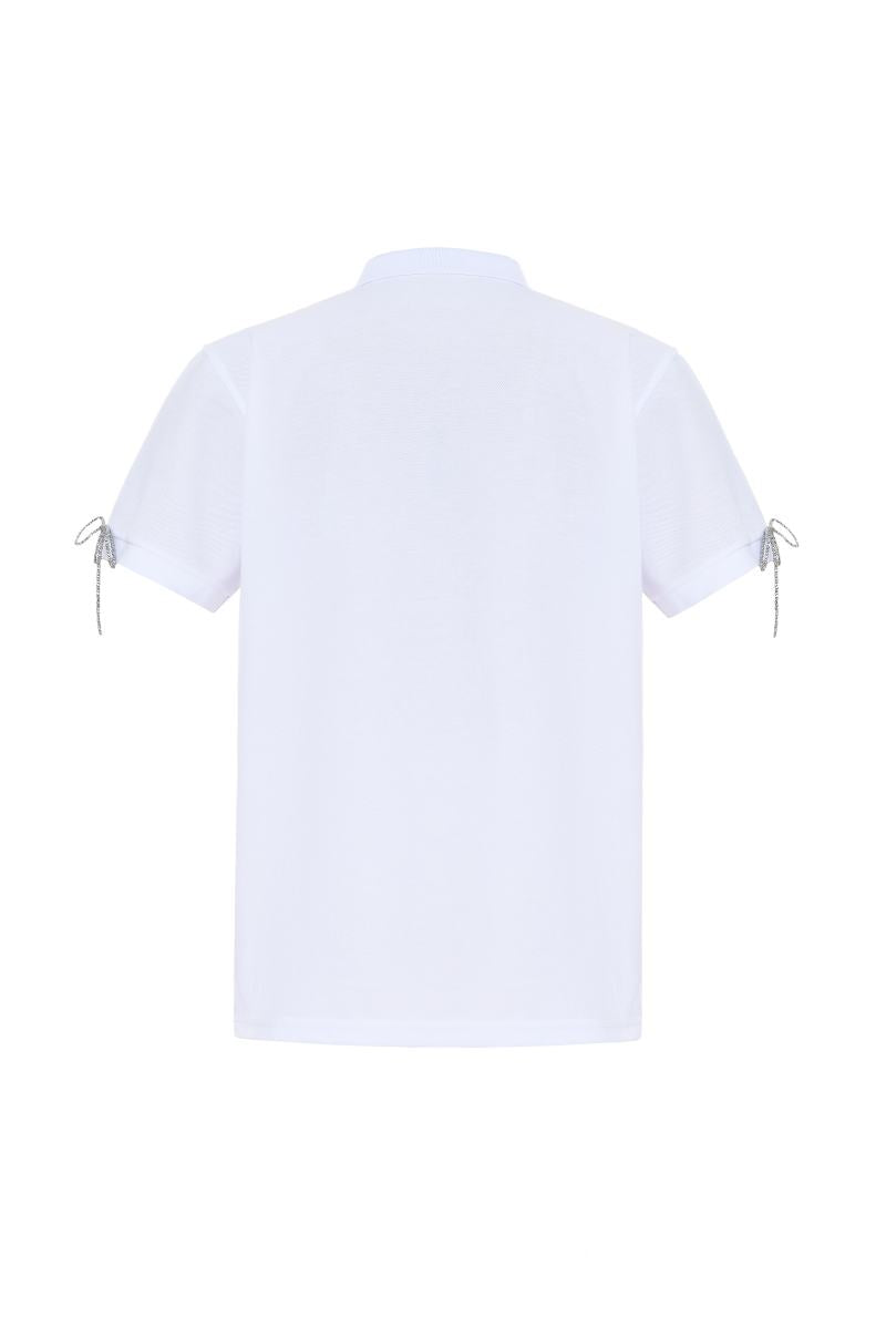 Gvasalia white polo shirt with crystal bow ties, stylish tops with silver accents, close-up of the elegant design and fabric details.