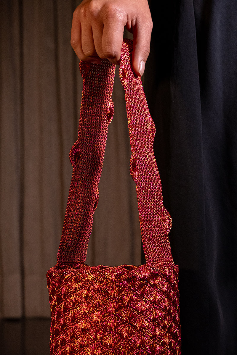 Copper and magenta seashell shoulder bag by VERDI with intricate design and shoulder strap, stylish accessory for casual or evening wear.
