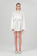 White Nina dress by Izakova, a stylish mini dress with a fitted silhouette, showcased on a model in a fashion photoshoot.