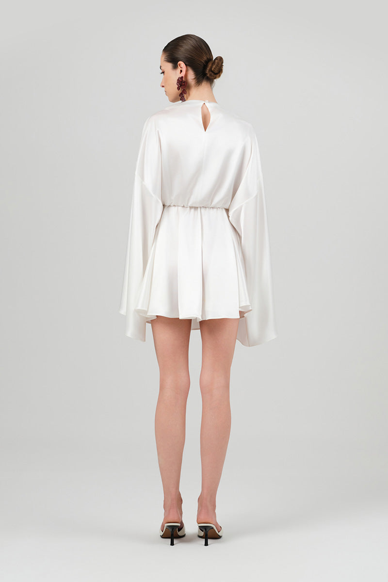 White Nina dress by Izakova, a stylish mini dress with a fitted silhouette and elegant design, shown on a model.