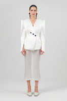 Izakova white satin pants with a sleek, smooth fabric and tailored fit, showcased on a neutral background.