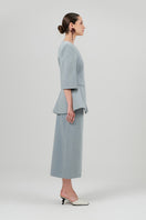 Izakova NELA blazer in washed blue, tailored fit with lapel collar and button closure, displayed on a hanger.