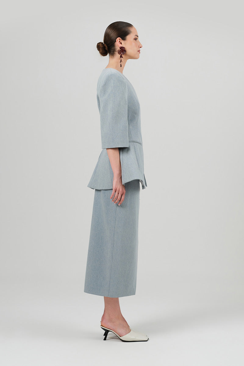 Izakova NEDA washed blue midi skirt with a flowy, lightweight fabric and a relaxed fit, displayed on a hanger.