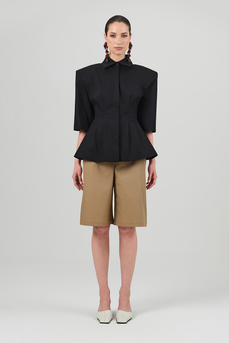 Black Izakova EDISA shirt with a classic fit, shown on a hanger with a smooth fabric texture and simple collar design.