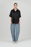 Black satin Rosa shirt by Izakova, featuring smooth fabric and classic design, displayed on a hanger.