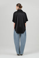 Black satin Rosa shirt by Izakova, featuring a sleek, elegant design with smooth fabric and tailored fit.