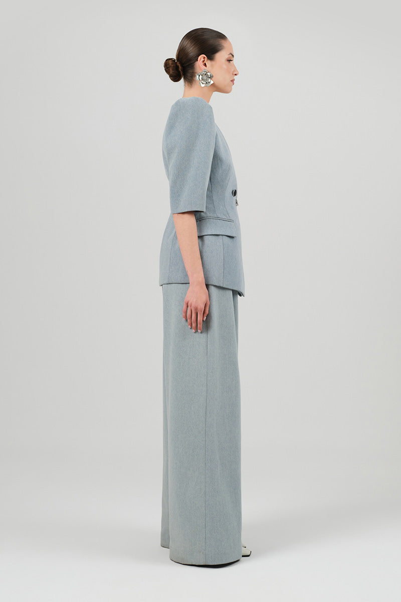 Izakova Tessa pants in washed blue, casual cotton pants with relaxed fit and subtle distressing, styled for everyday wear.