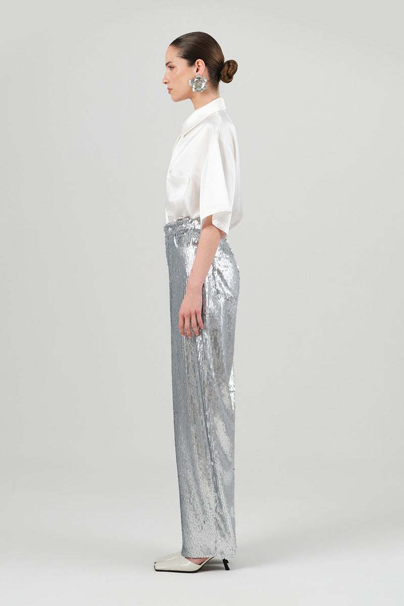 Silver sequin jeans by Izakova featuring a stylish fit, perfect for a trendy and eye-catching look.