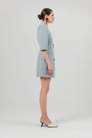 Izakova Mila blazer dress in washed blue, mini length with tailored fit and lapel collar, displayed on a hanger.