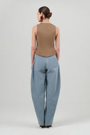Izakova washed blue jeans displayed on a hanger, showing a classic fit with a slightly faded denim finish.