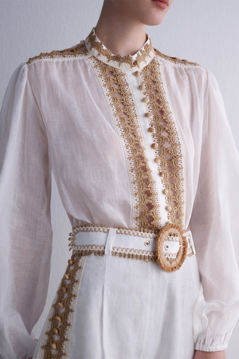 AISA DUNE shirt made of soft fabric, featuring a stylish design and collar, displayed on a hanger against a neutral background.