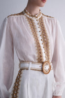 AISA Dune shirt displayed on a hanger, featuring a stylish design with a collar and button-front closure.