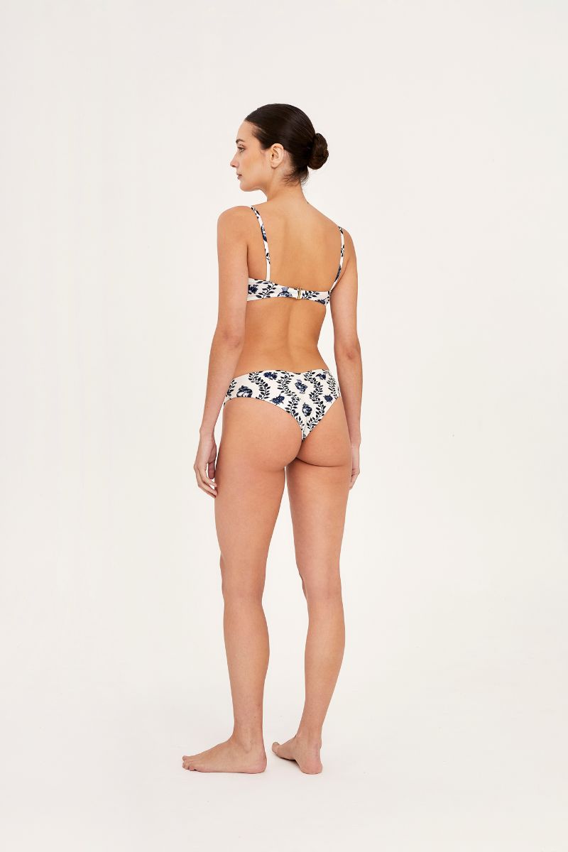 Aguaclara Dynasty Hipster Bikini Bottoms in vibrant print, shown on a model with a seamless fit and mid-rise design.