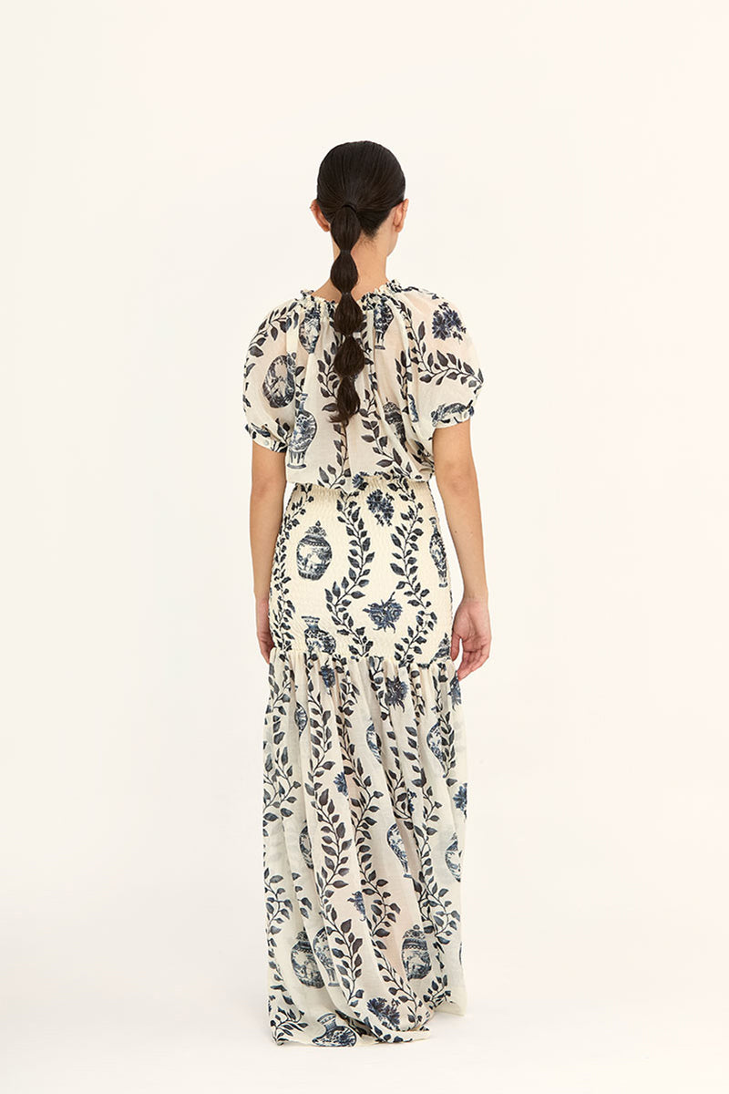 Aaguaclara Dynastie maxi dress in flowing fabric with floral pattern, sleeveless design, and V-neck style.