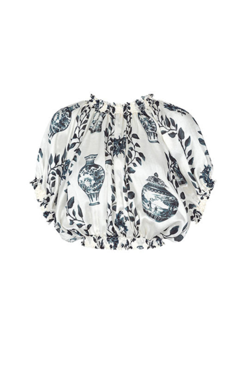 Aguaclara Dynastie crop top in vibrant fabric with a fitted design, shown on a white background.