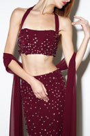 Rayane Bacha Dalya embellished halter co-ord set in burgundy, featuring intricate detailing and a stylish halter top.