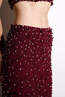 Burgundy Rayane Bacha Dalya embellished halter co-ord set with intricate beadwork and a fitted halter top and matching pants.