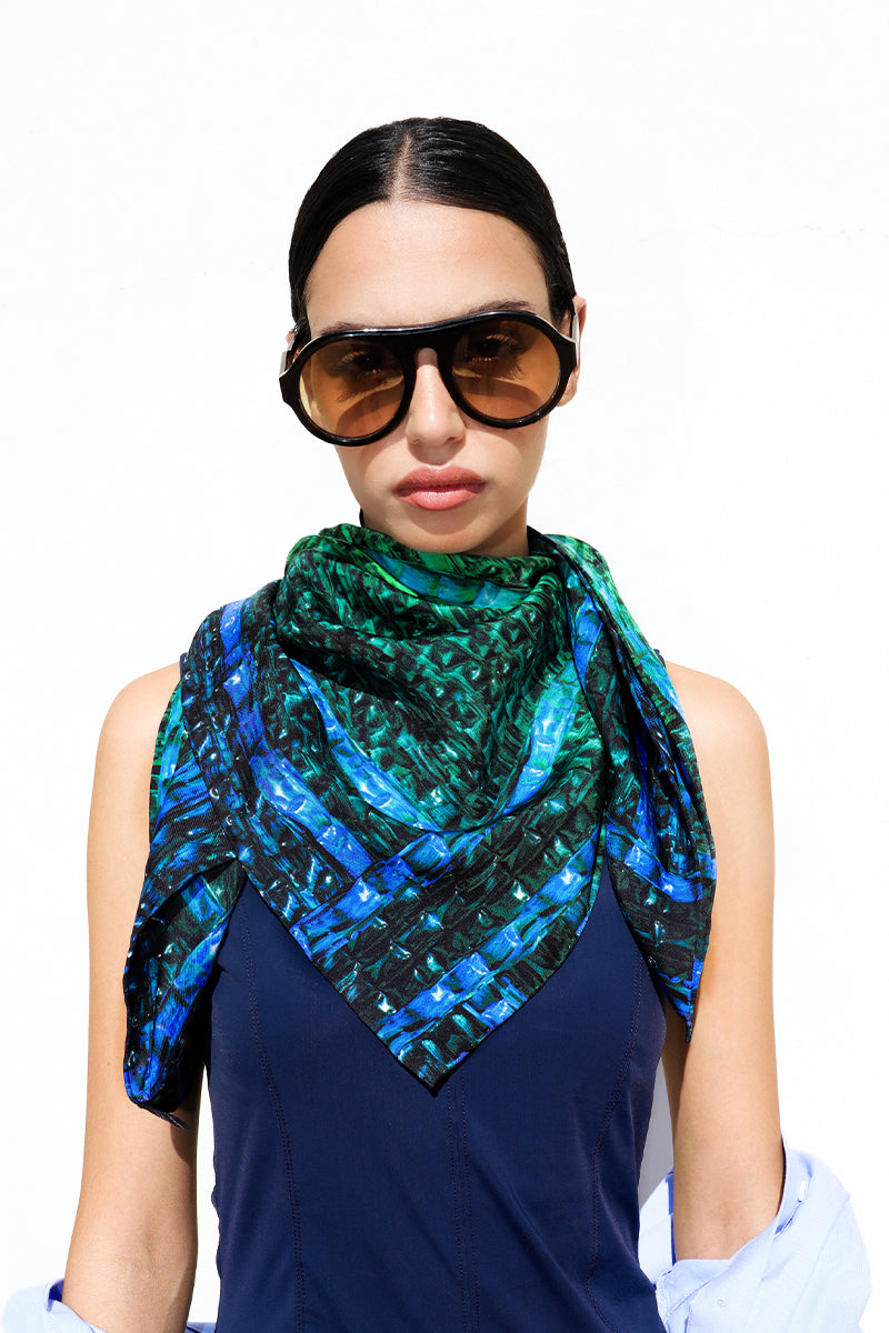 Elegant silk scarf by Amel Batita featuring the Darq Brocot pattern, draped to showcase vibrant colors and intricate design details.