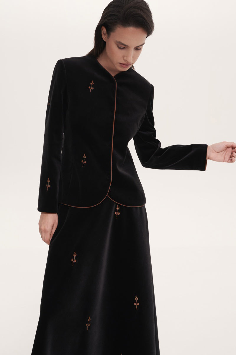 Black rose embroidered jacket by Delegan, featuring detailed floral embroidery on a stylish outerwear piece.