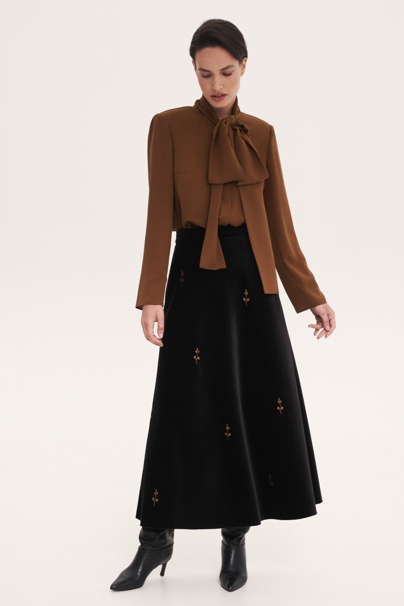Brown blouse with scarf accessory from DELEGAN, featuring a stylish shirt design and elegant neckline.