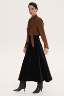 Black rose embroidered midi skirt by Delegan, featuring floral embroidery and a flowing, elegant design.