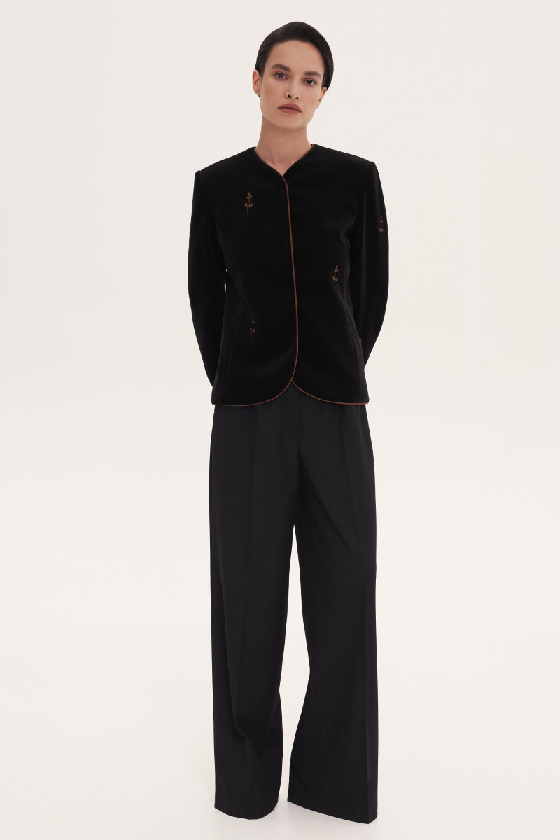 Black rose embroidered jacket by Delegan, stylish outerwear with intricate floral embroidery, casual and fashionable for everyday wear.